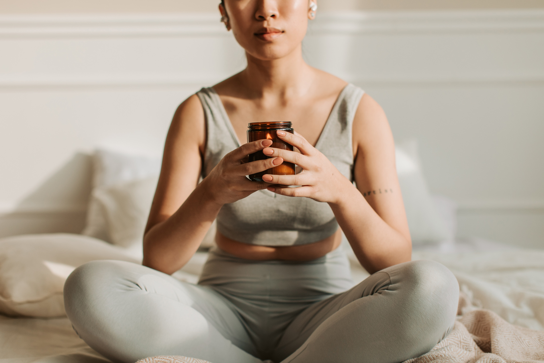 Woman Meditating While Holding a Lighted Candle